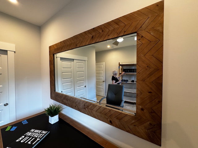 Wooden chevron framed bevel mirror; 73x43