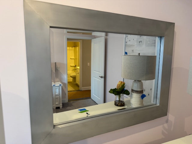 Silver framed bevel mirror; 45x32